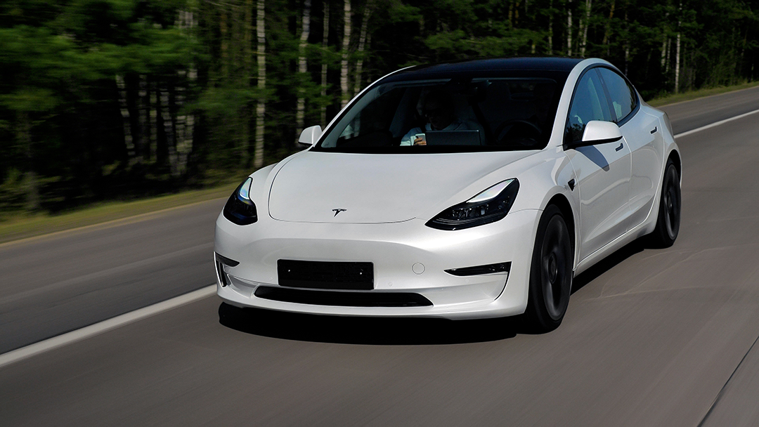 Tesla driving down the road.