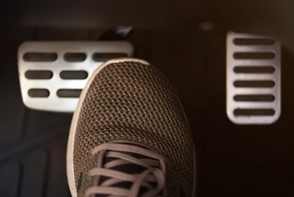 Driver's foot pressing the brake pedal