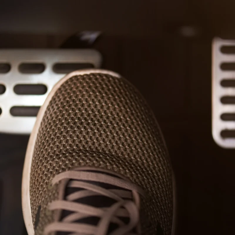 Driver's foot pressing the brake pedal