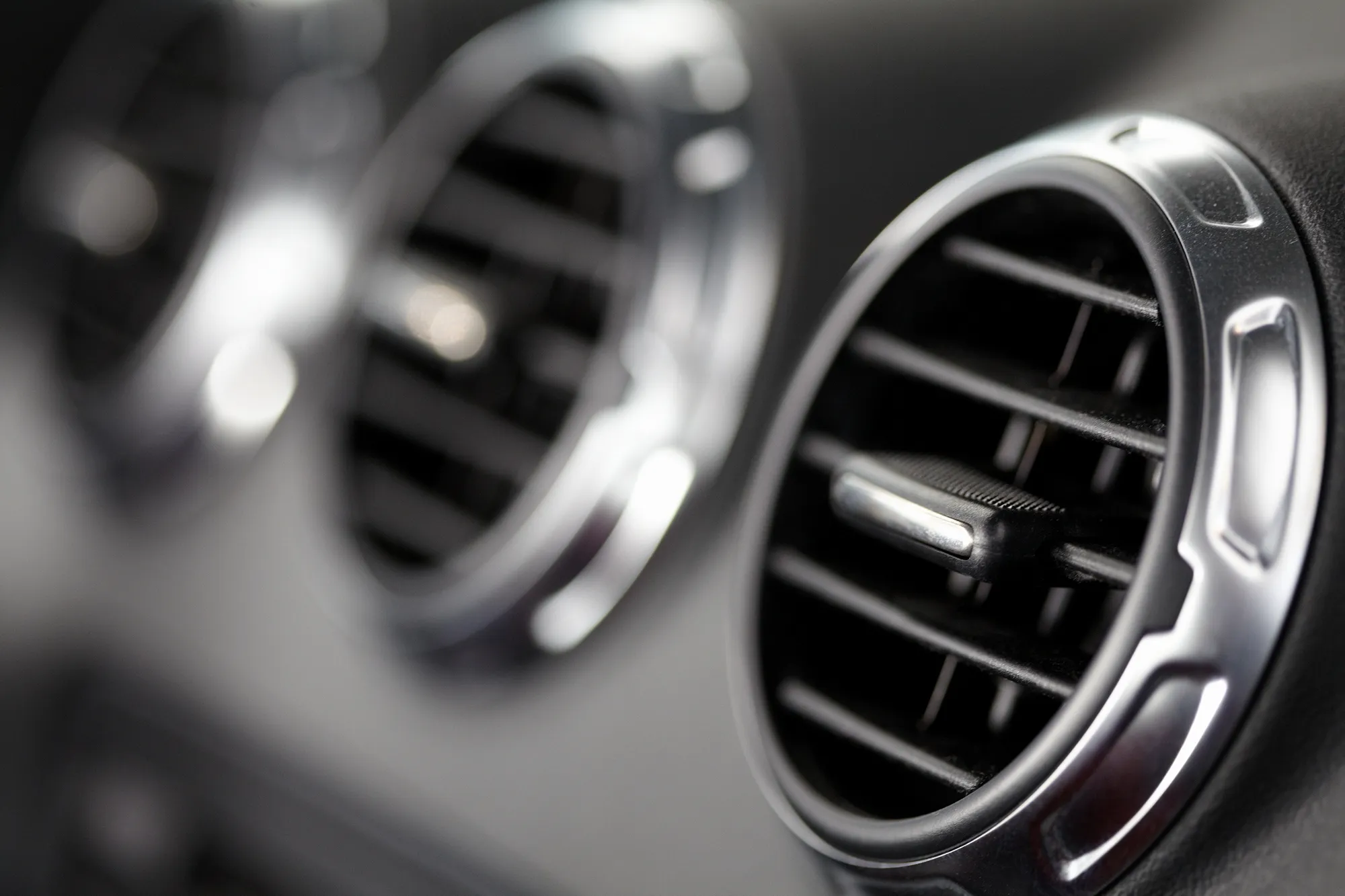 Close-up of a car dashboard air conditioning vents